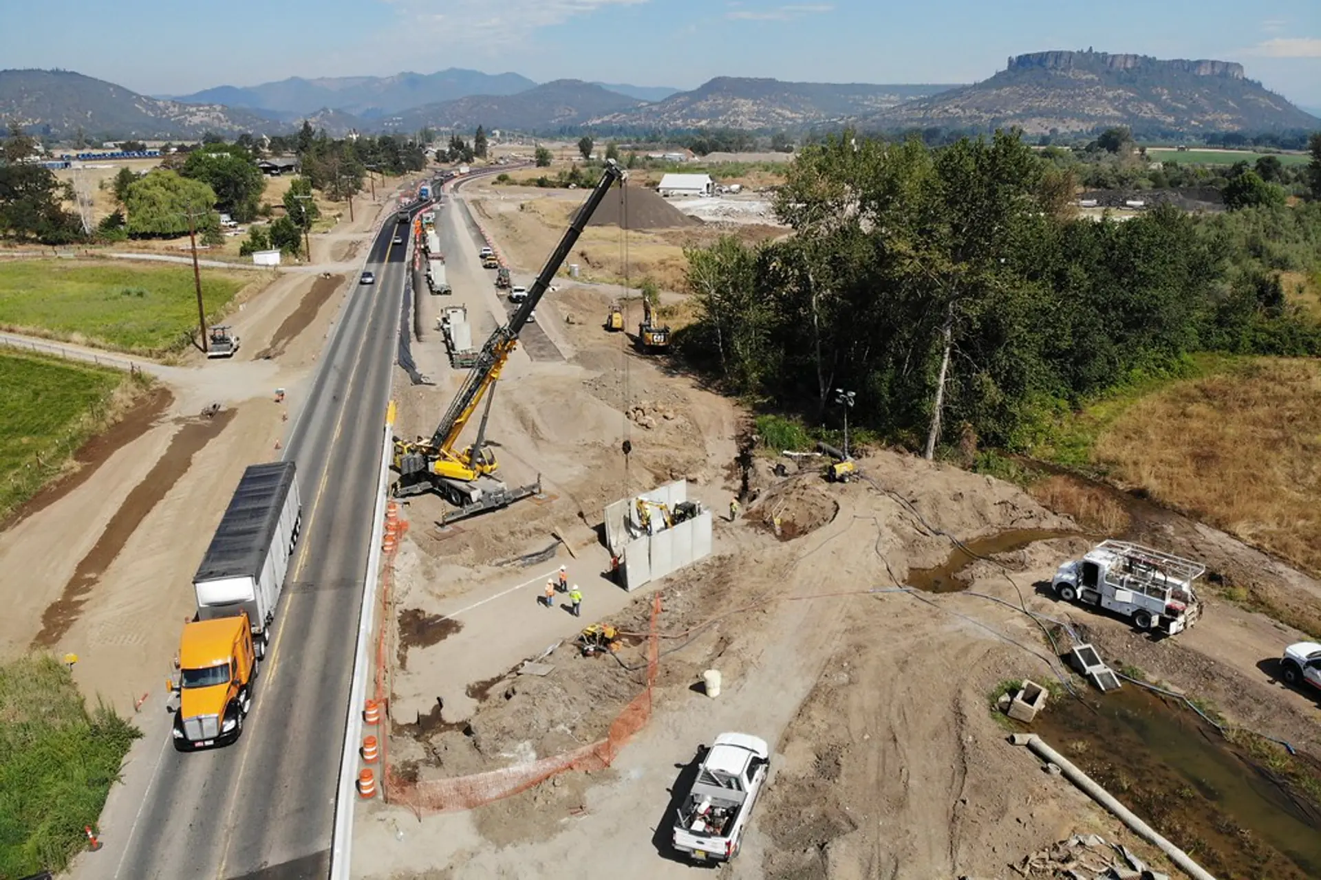 Crane installing a precast box culvert on a precast concrete roadway job site in Endicott, NY