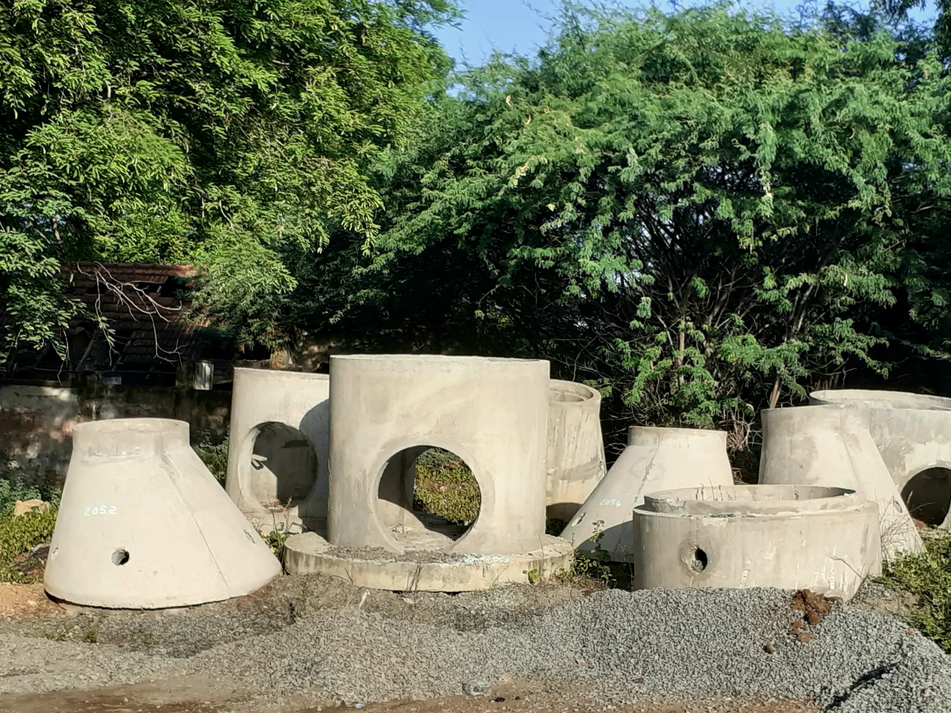 Watertight precast concrete tanks and manhole structures staged for installation in Owego, NY