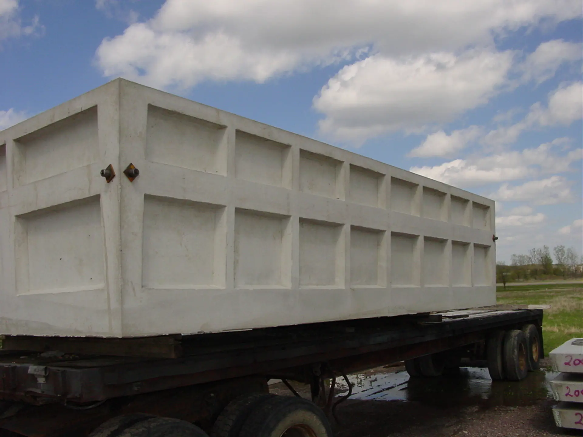 Large precast concrete utility vault loaded for delivery to a precast concrete site in Binghamton, NY